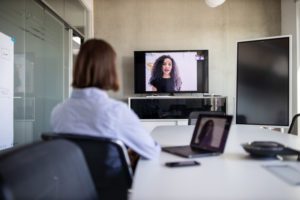 Woman using conference room video technology